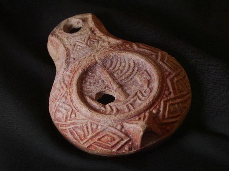 The rare 1,700-year-old oil lamp, decorated with Temple symbols