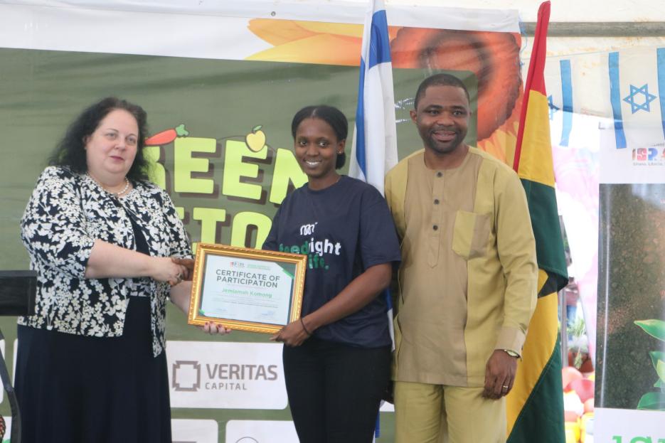 Judith Eyram Aketey receives a Certificate from Ambassador Cooper (photo credit: MFA Accra) Judith Eyram Aketey receives a Certificate from Ambassador Cooper