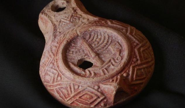 The rare 1,700-year-old oil lamp, decorated with Temple symbols